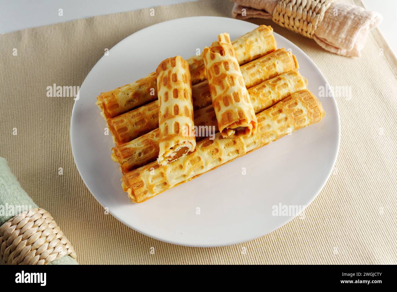 Ethereal Morning Delight: A Gourmet Stack of Golden Waffles on a Crisp White Plate Stock Photo