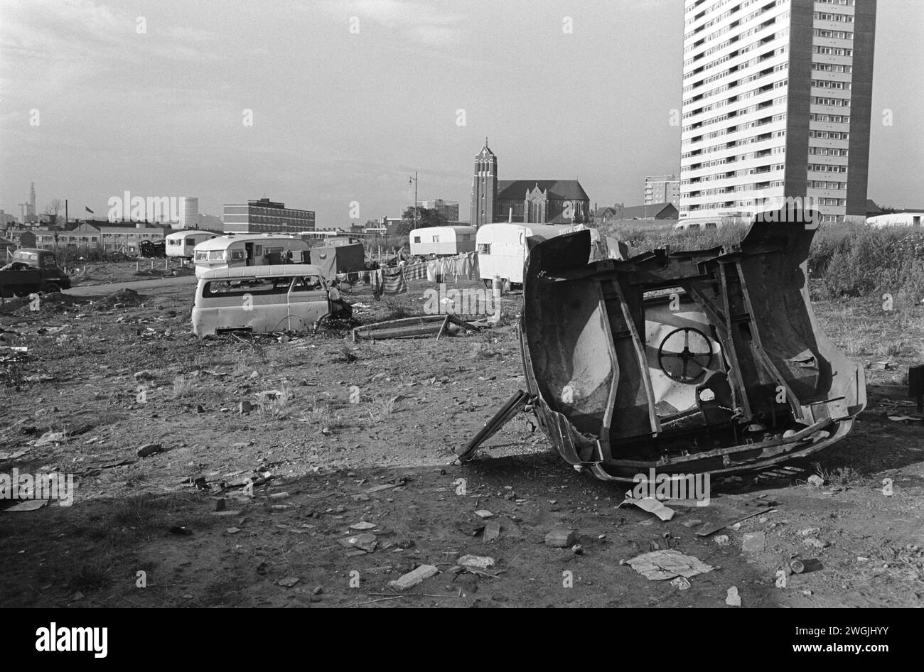 A gypsy Irish travellers encampment and temporary scrap car dump on waste ground in Balsall Heath, an inner city slum and area. Balsall Heath, Birmingham, England March 1968 1960s UK HOMER SYKES Stock Photo