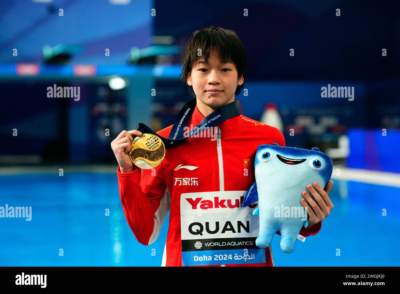 Hongchan Quan of China holds up her gold medal after winning the women