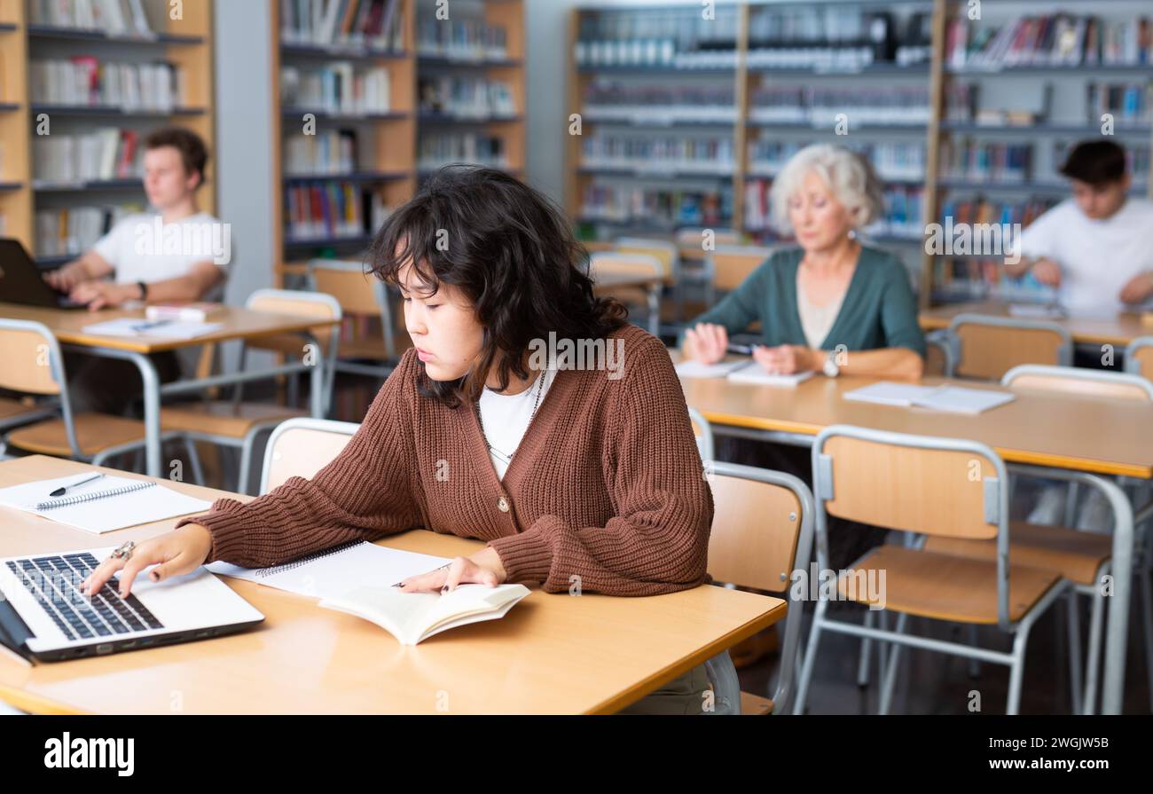Library Do Homework Fifteen-old-year schoolgirl doing homework in the school library Stock ...
