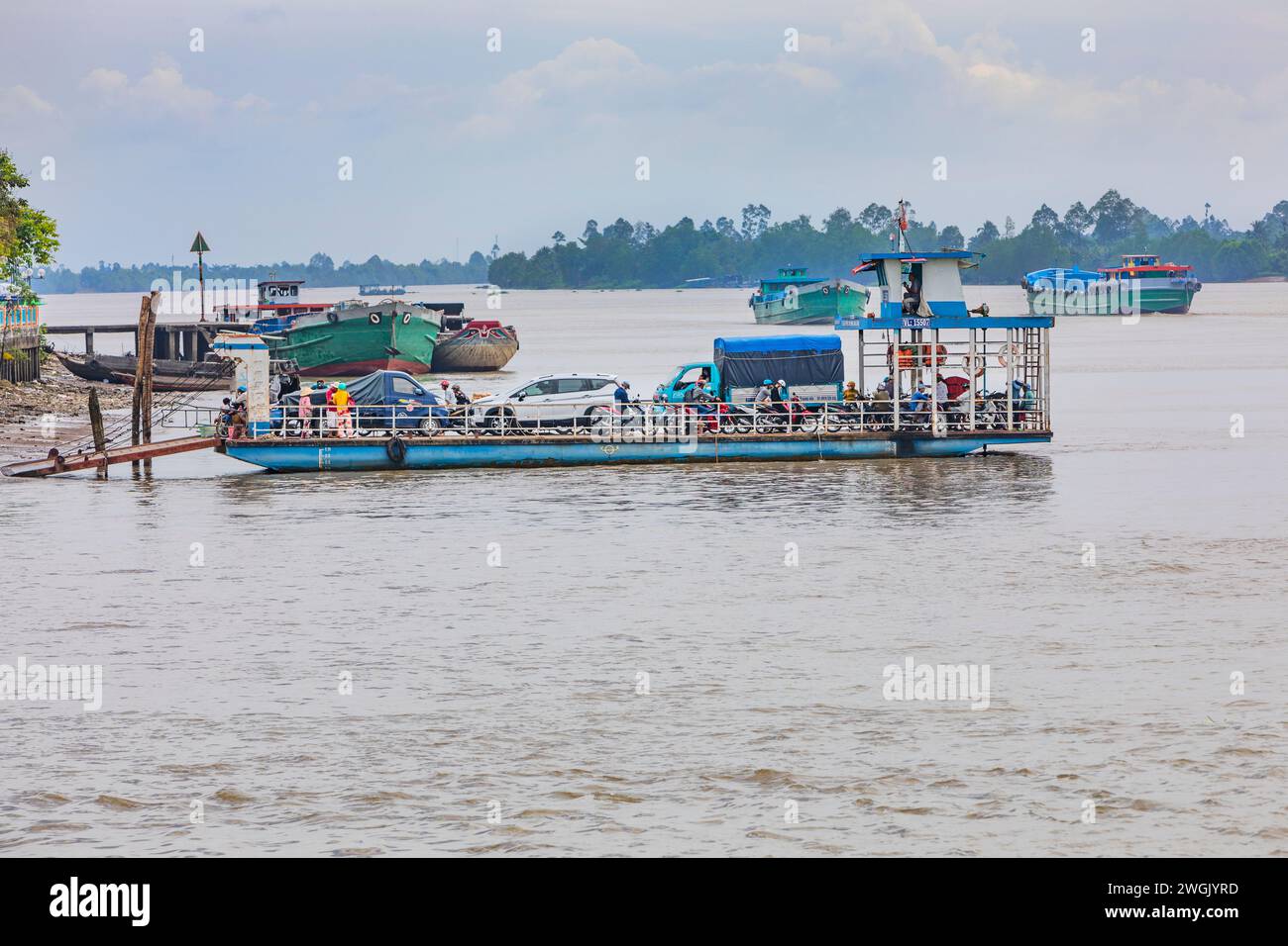 A local cross river ferry in the Mekong Delta disembarking. Stock Photo