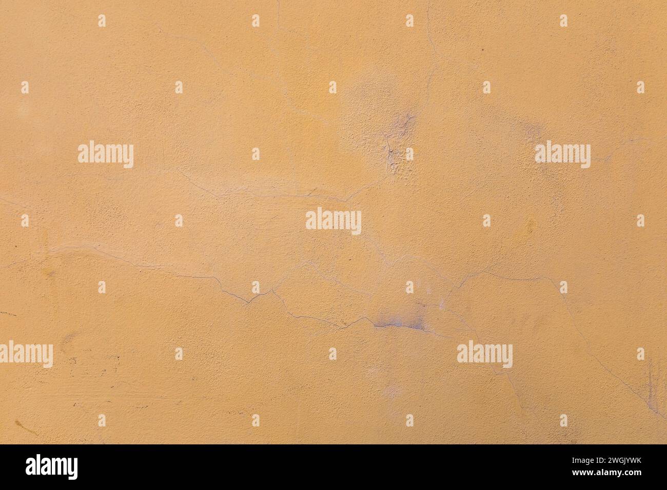 yellow orange  stucco wall, texture, peeling paint.background Stock Photo