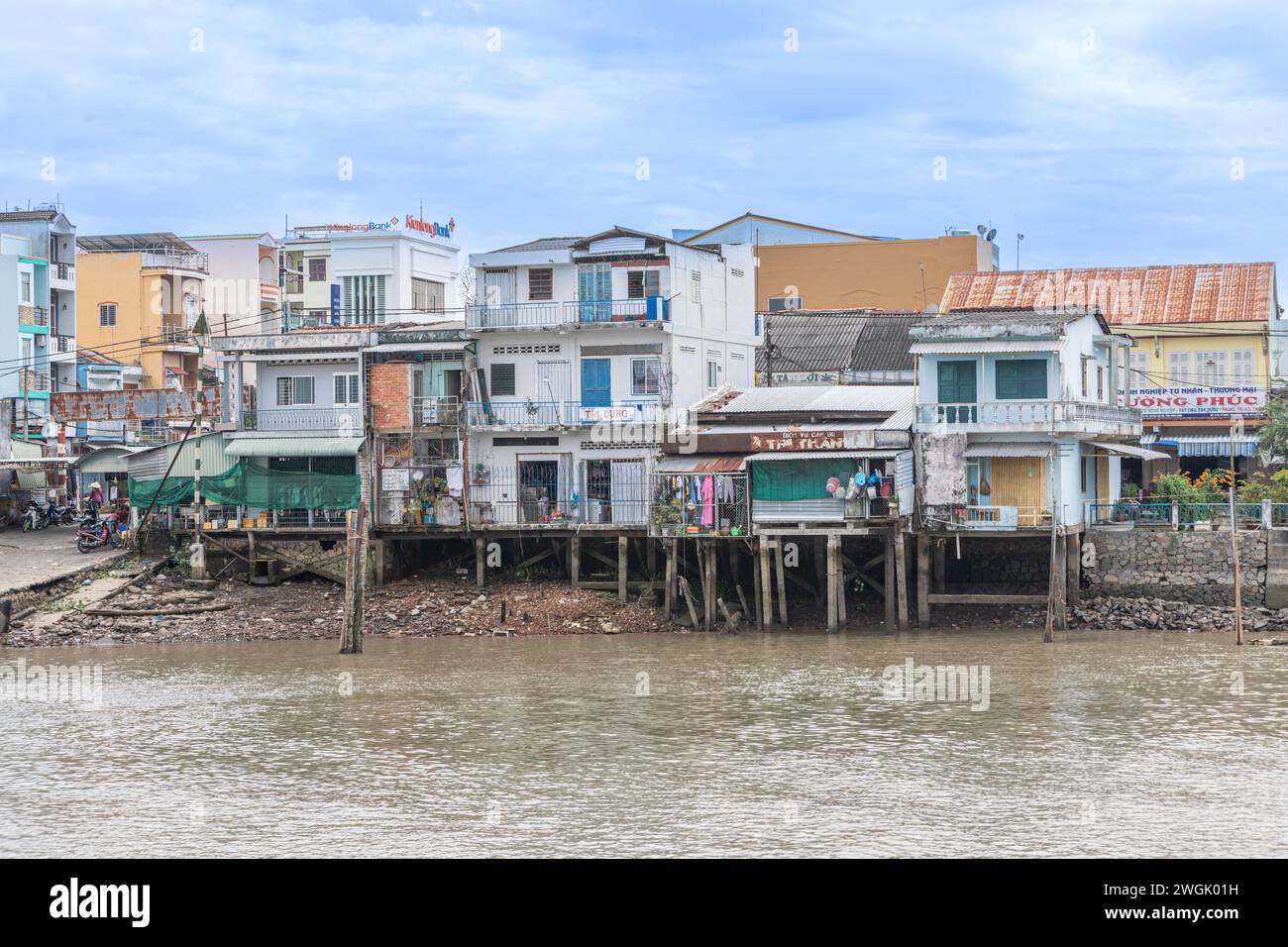 Riverside houses and businesses in Vinh Long, Vietnam. Stock Photo