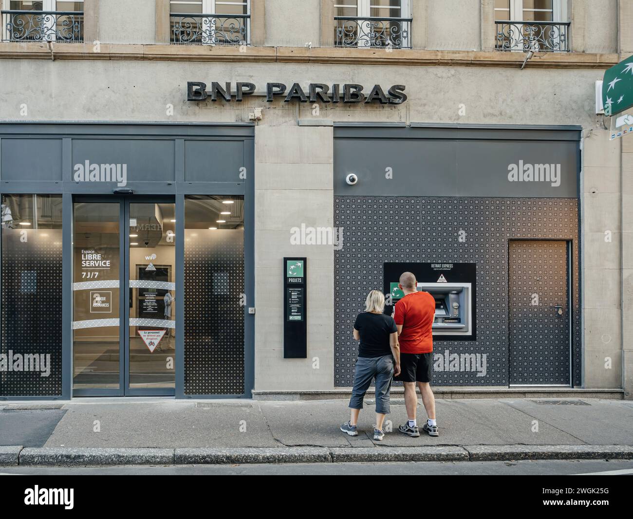 Strasbourg, France Jul 2, 2023 A couple stands in front of the BNP Paribas bank branch