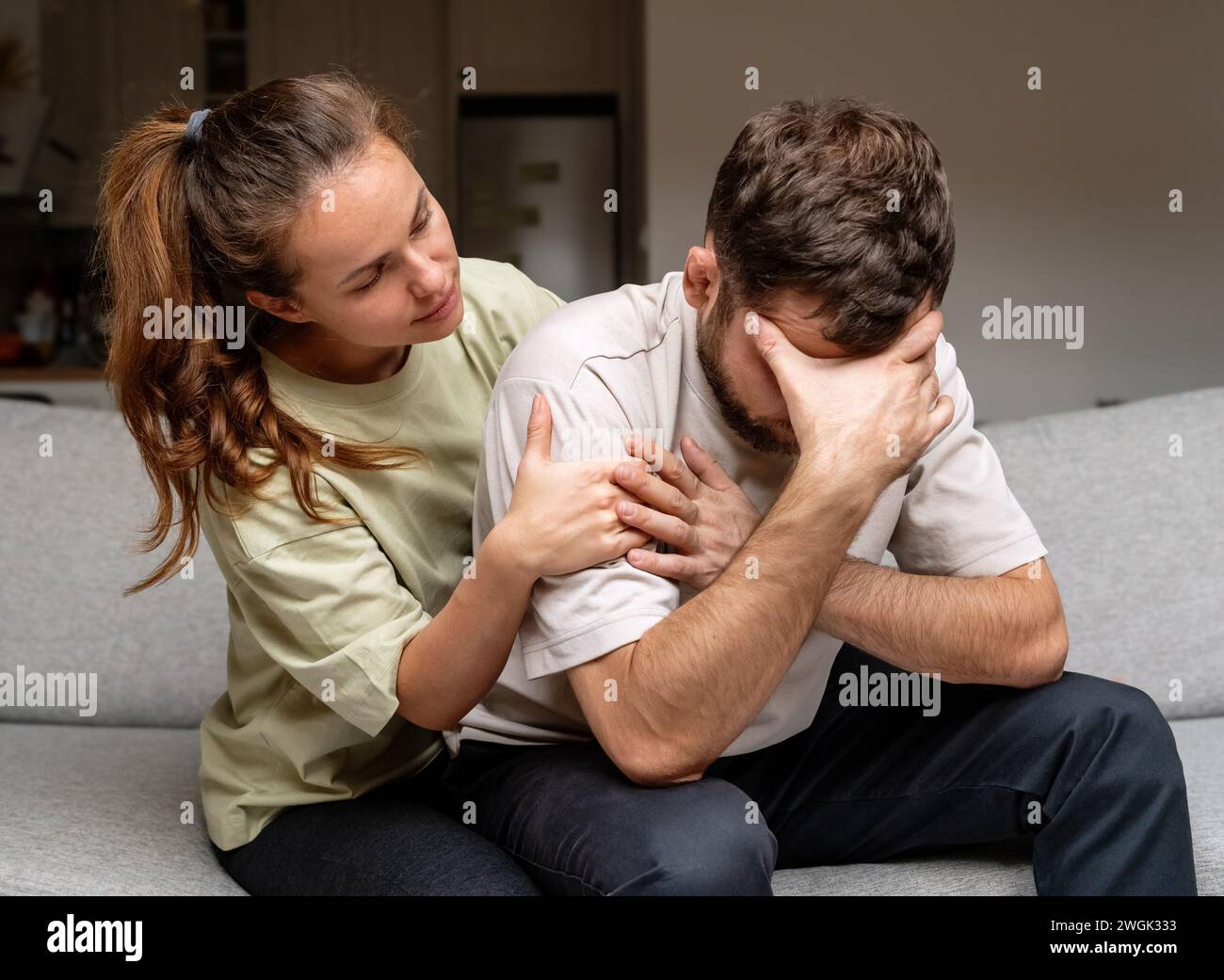 Relationship difficulties. Midlife crisis in men. Disappointed man and his wife at home. Mental illness. Stock Photo