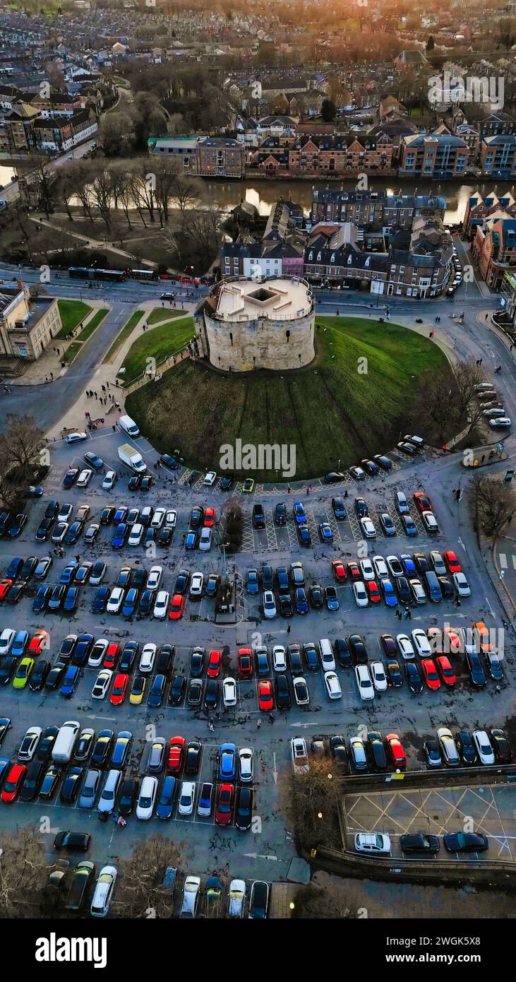 Aerial view of a circular building surrounded by a parking lot with cars during twilight in York, North Yorkshire Stock Photo