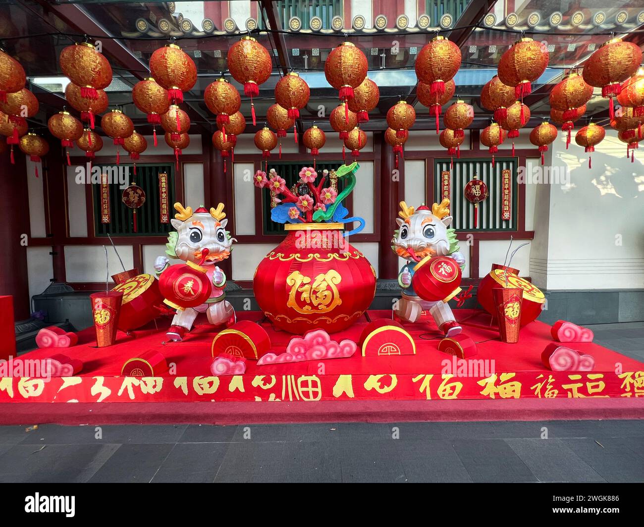 Singapore, Chinatown, preparation to the Chinese New Year, with bright red and gold decorations on display. Cute dragon installation. Stock Photo