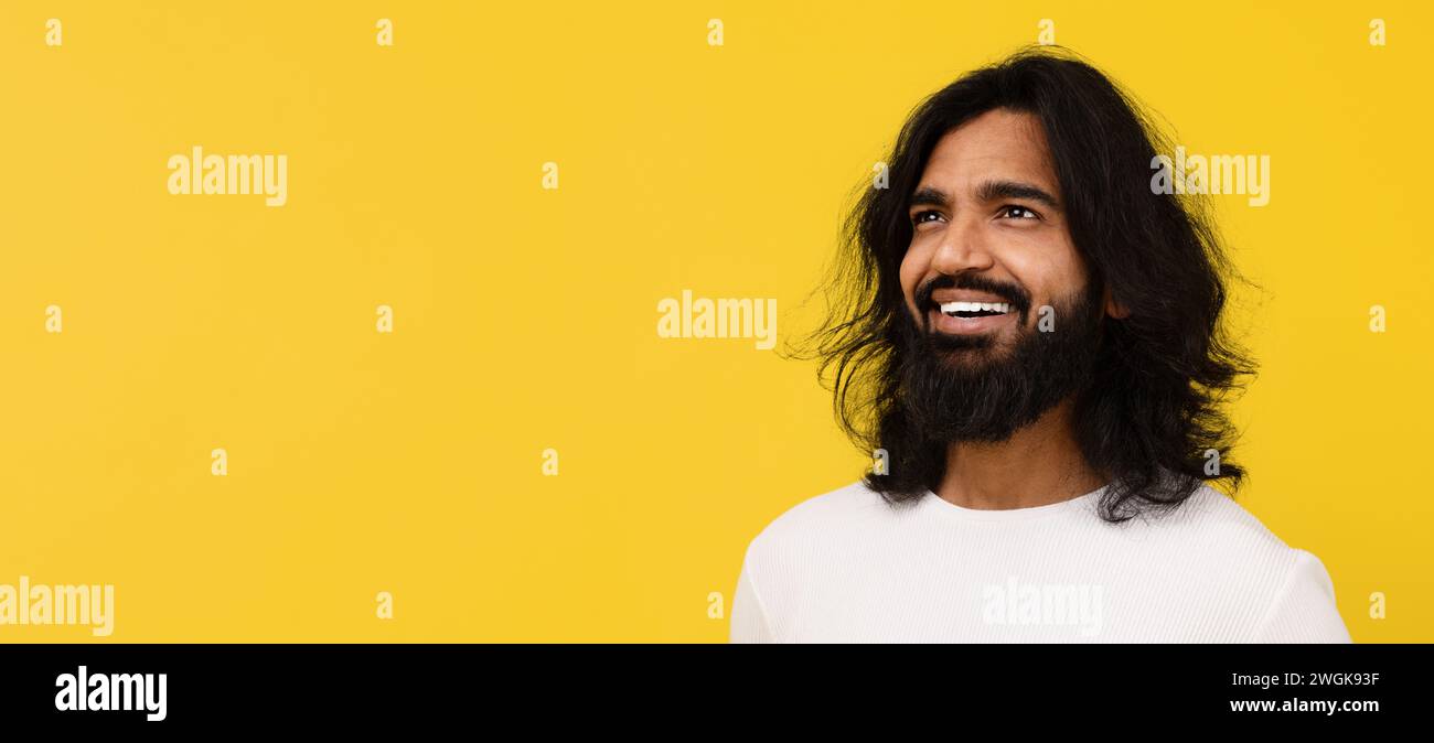 Curious young indian man looking at free space Stock Photo