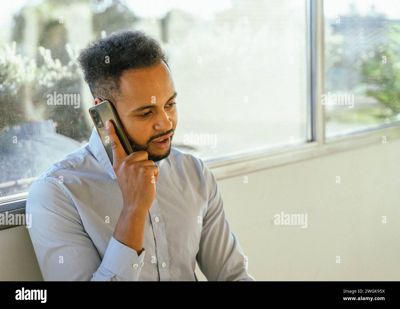 Businessman talking on the phone in the office. Business and technology concept. Stock Photo