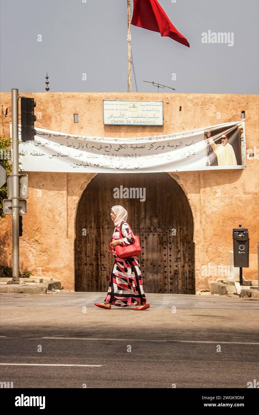 A woman walks past a gateway to the medina. Rabat, Morocco's capital ...