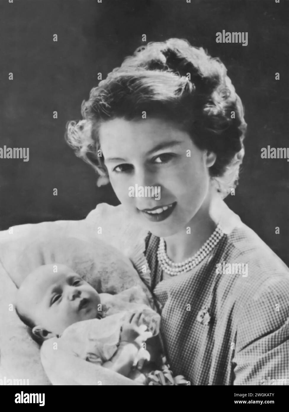 Portrait of Elizabeth II holding her newborn daughter, Princess Anne, in 1950. Born on August 15, 1950, this image offers a glimpse into the family life of Elizabeth, at a time just before her ascension to the British throne in 1952. Stock Photo