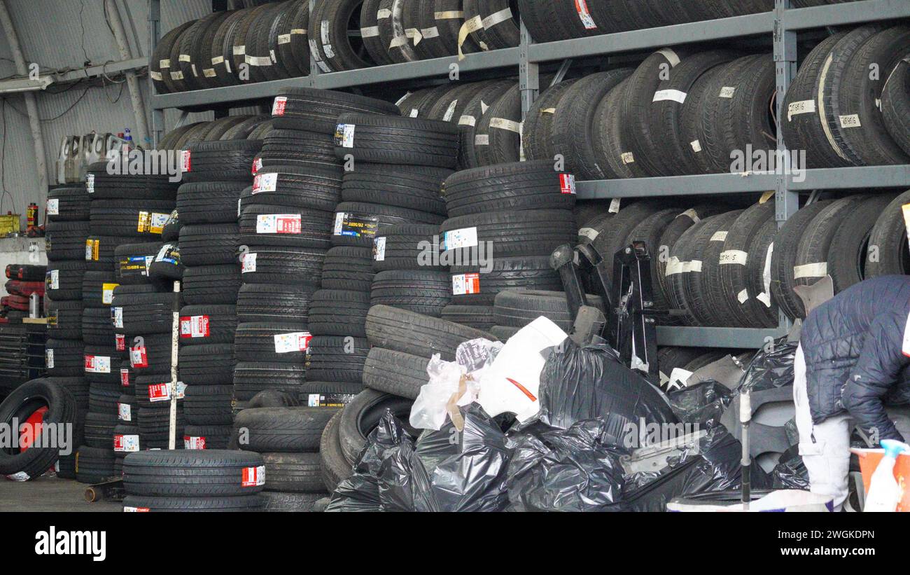 Barry, Vale of Glamorgan, Wales 02 Feb 2024: Tyre sale stored in an arched vintage industrial unit on dockland. Stock Photo