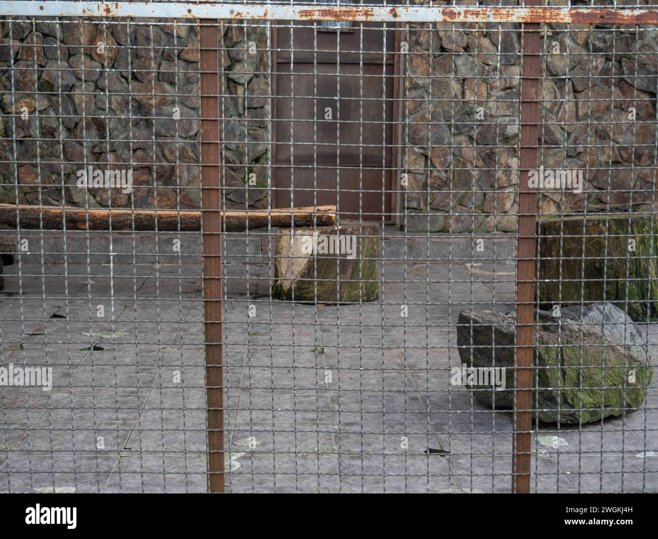 Outdoor fence at the zoo. Empty cages in the zoo. Winter at the zoo
