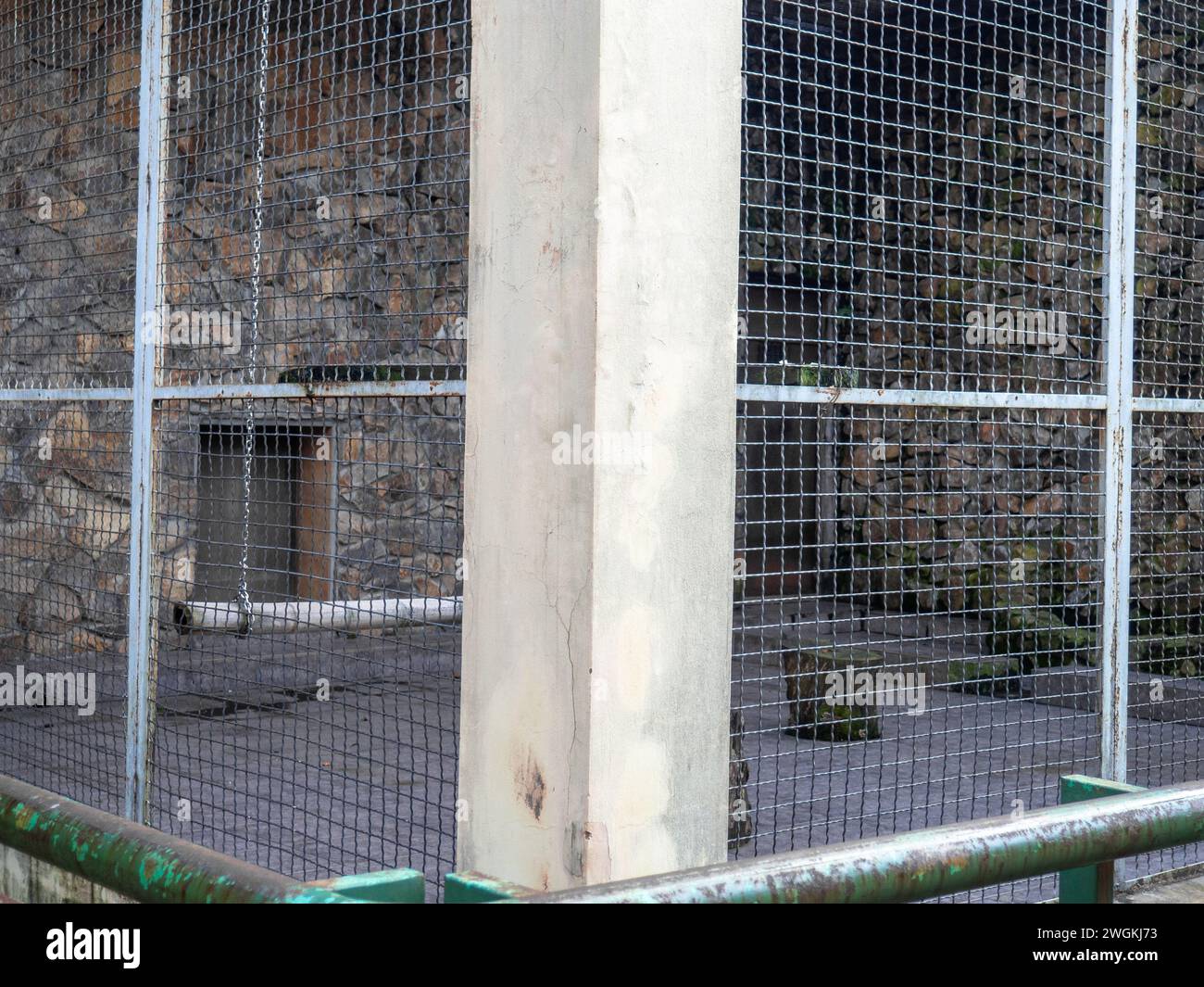 Outdoor fence at the zoo. Empty cages in the zoo. Winter at the zoo