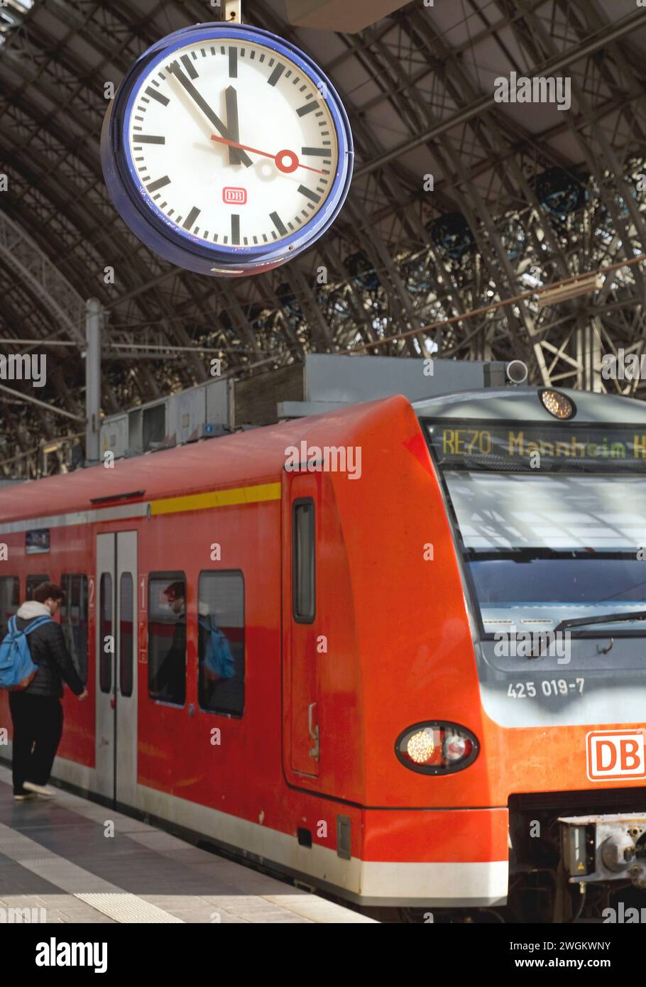 Local trains at Frankfurt main station with station clock, Germany, Hesse, Frankfurt am Main Stock Photo