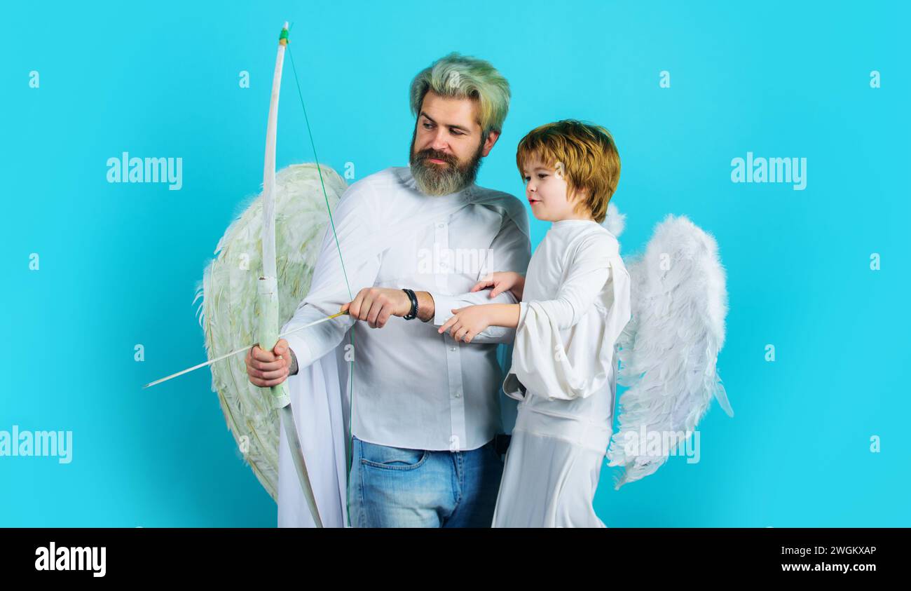 Valentines day celebration. Arrows of love. Valentines cupid angels cute child boy and bearded man shooting arrow from bow. Father's day. Smiling Stock Photo