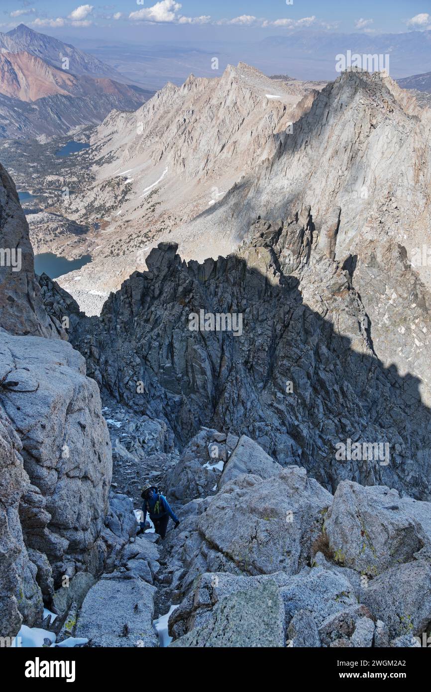 woman scrambling up the final slope to the summit of Mount Thompson in the Sierra Nevada Mountains Stock Photo