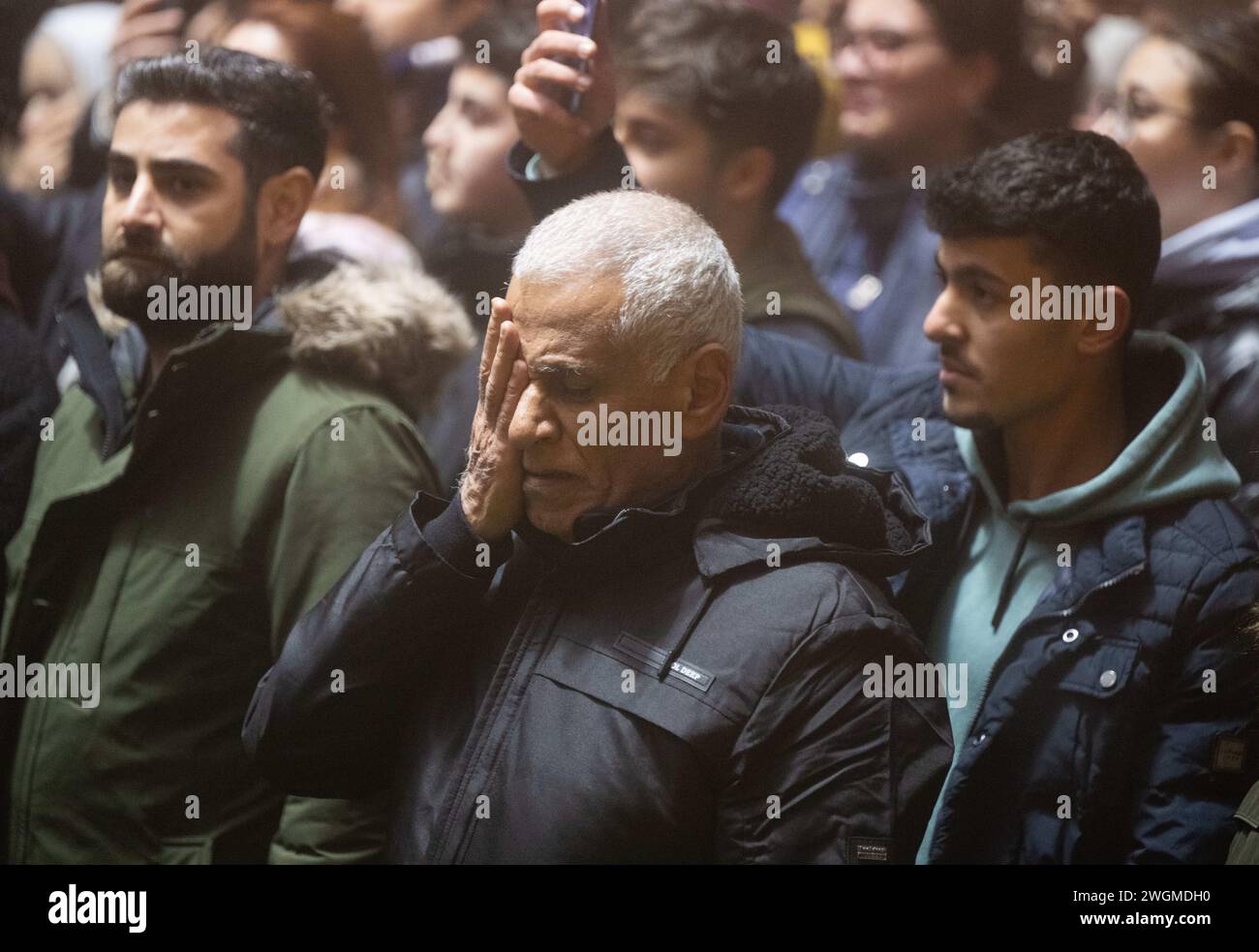 Antakya, Turkey. 06th Feb, 2024. A man grabs his face at a rally for the earthquake victims. A year ago, tens of thousands of people lost their lives in a massive earthquake in south-eastern Turkey. Credit: Boris Roessler/dpa/Alamy Live News Stock Photo