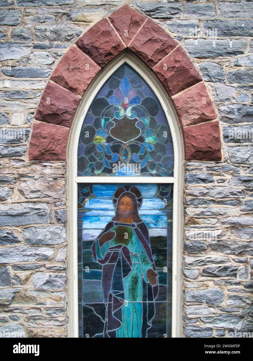 Stained glass depiction of Jesus Christ in arched window of Roman Catholic Church in Harpers Ferry, WV. Stock Photo
