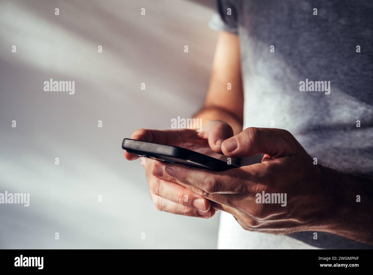 Man using modern smartphone portable information device to type text message, selective focus Stock Photo