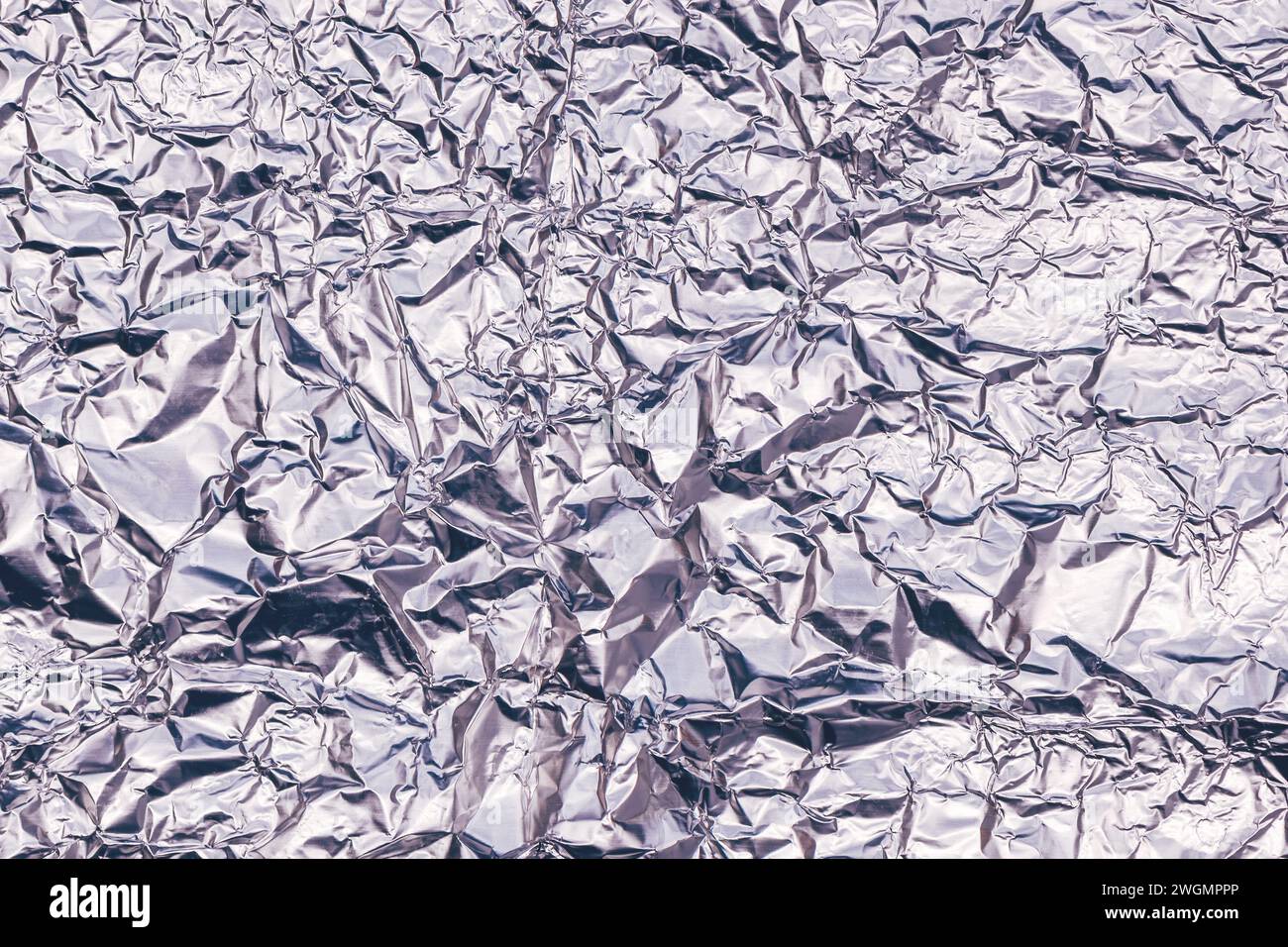 Crumpled aluminum tin foil texture as background, top view Stock Photo