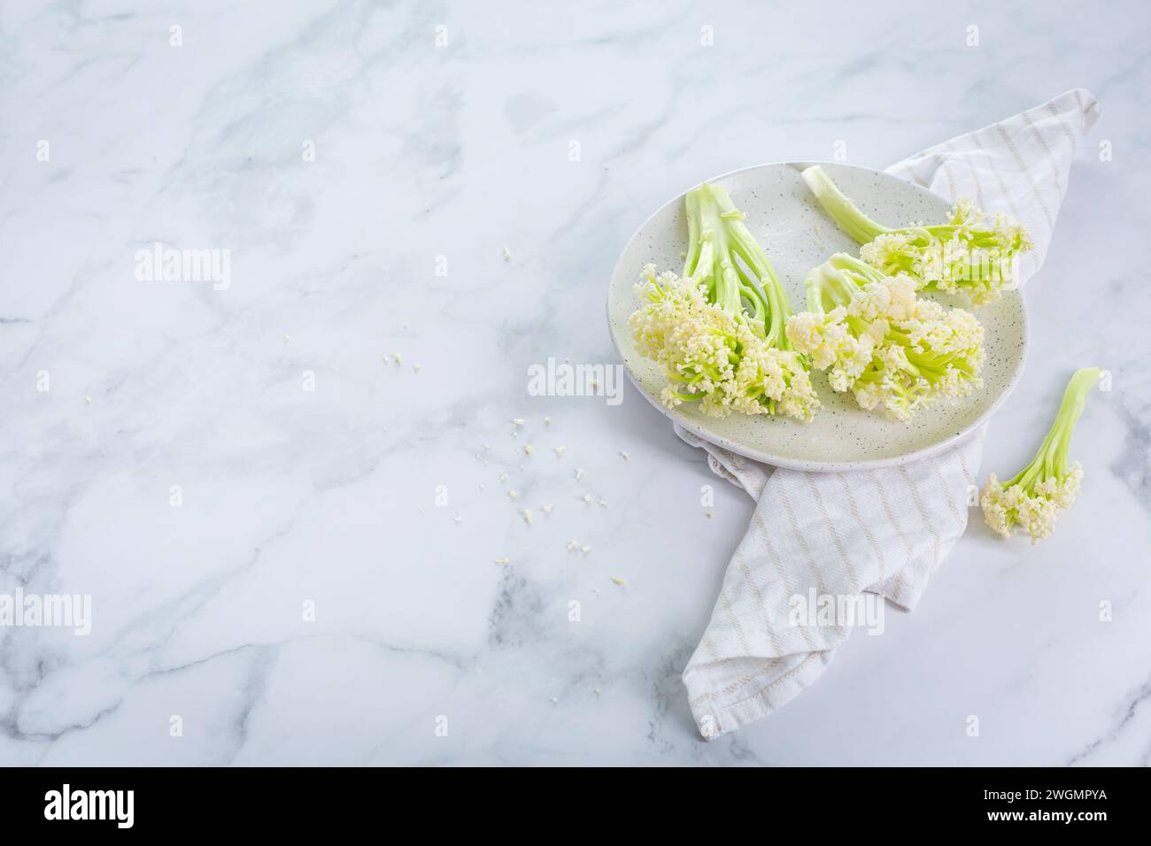 Raw organic baby stick cauliflower in a bowl. Stock Photo