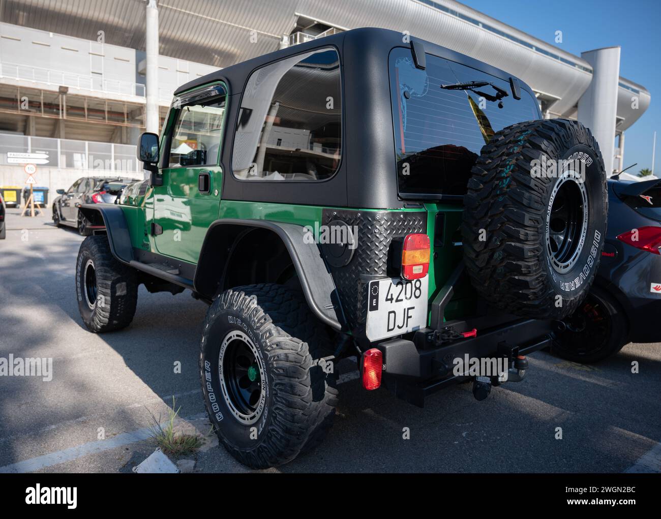 Rear view of a green Jeep Wrangler ready for adventure Stock Photo
