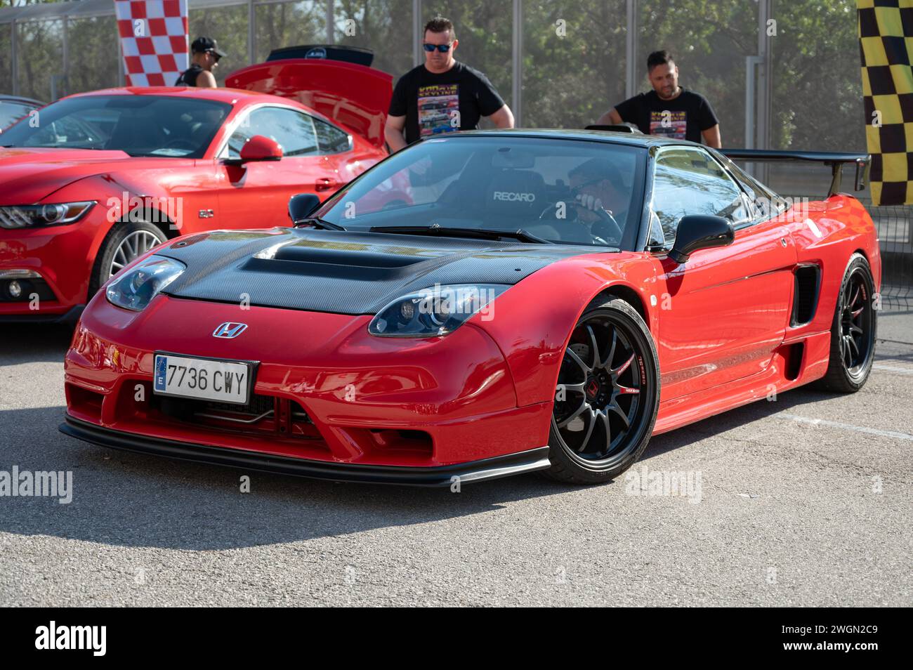 Front view of a stunning midengine V6 Honda NSX. It is red with black