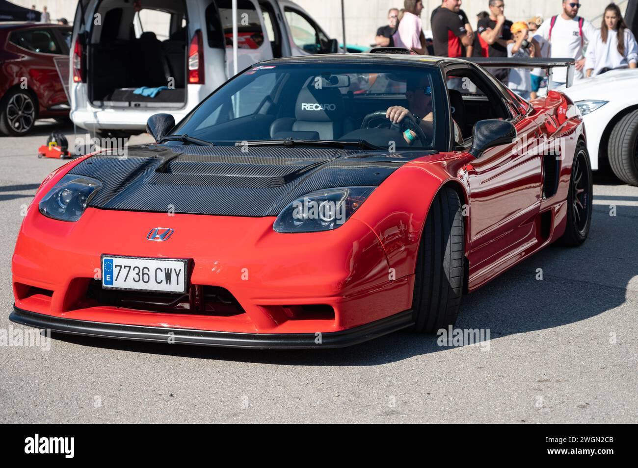 Front view of a stunning midengine V6 Honda NSX. It is red with black