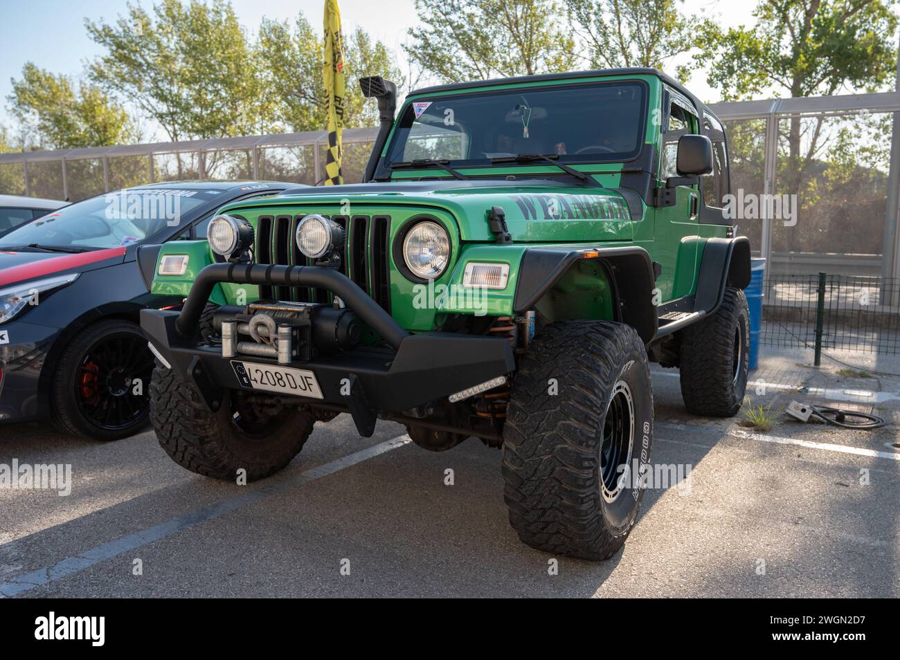 Front view of a green Jeep Wrangler ready for adventure Stock Photo