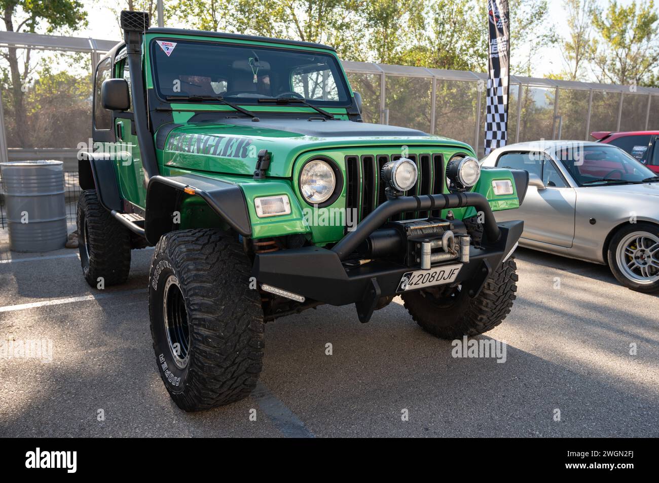 Front view of a green Jeep Wrangler ready for adventure Stock Photo