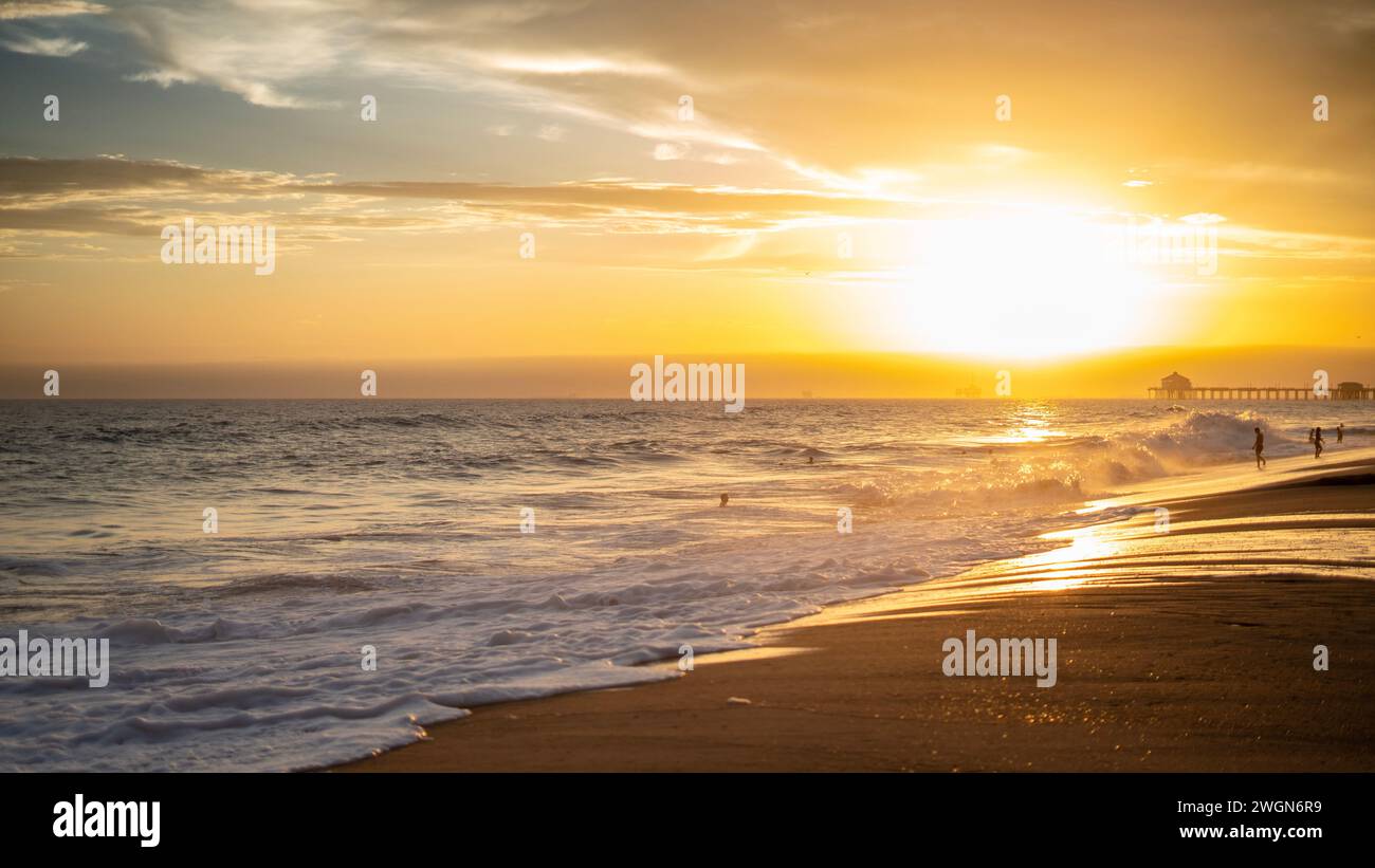 A stunning sunset with a picturesque sky over Huntington Beach, California Stock Photo