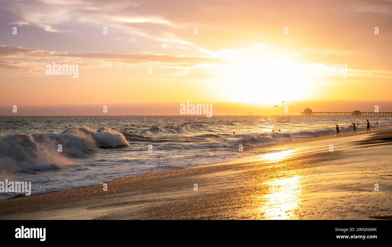 A stunning sunset with a picturesque sky over Huntington Beach, California Stock Photo
