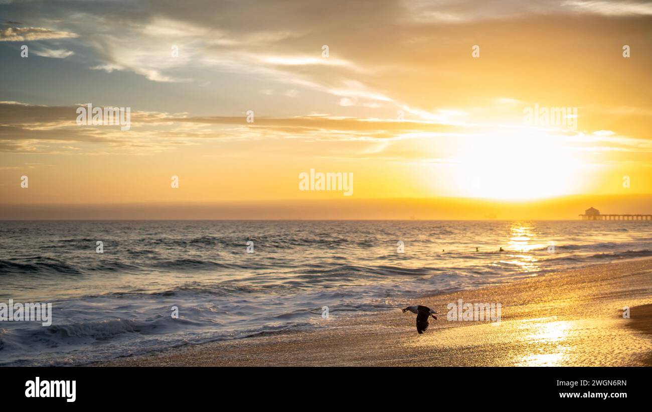 A stunning sunset with a picturesque sky over Huntington Beach, California Stock Photo