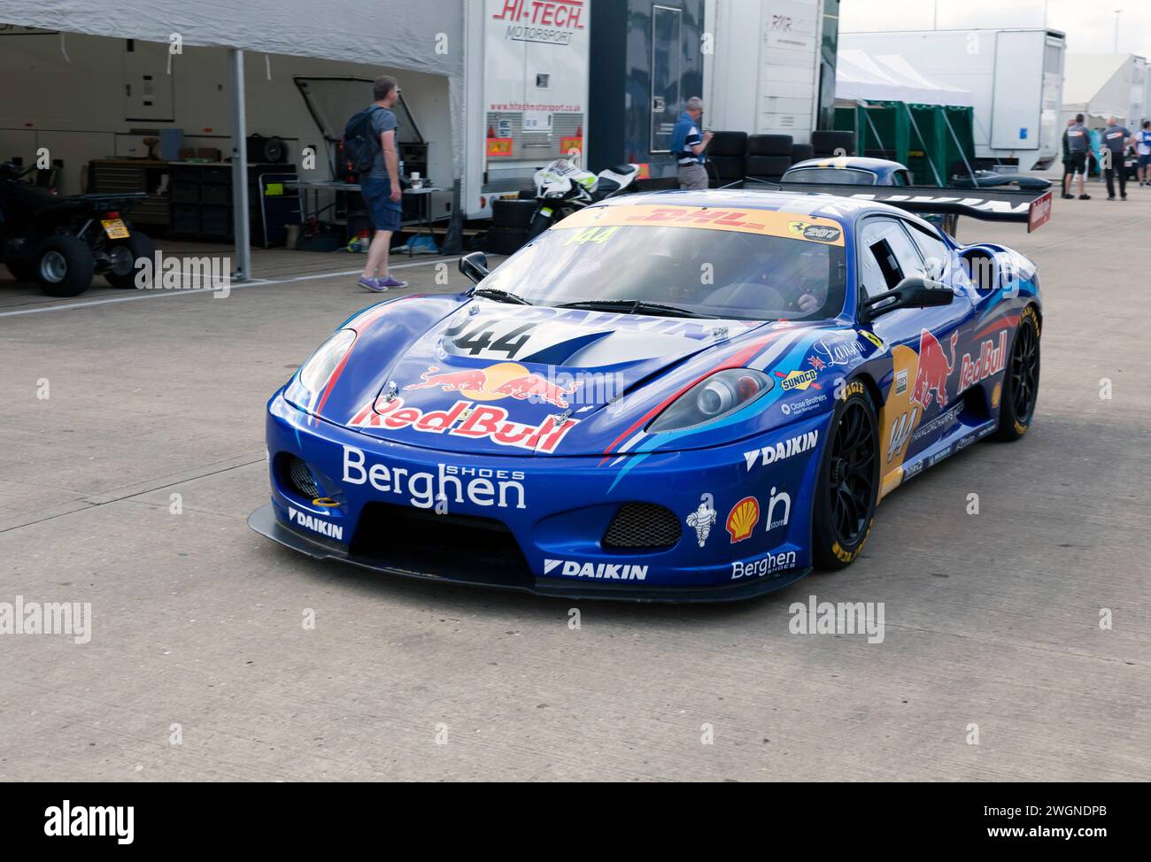 Three-quarters front view of Christopher Compton Goddard's Blue, Ferrari F430, driving through the International Paddock, before the Masters GT Trophy Stock Photo