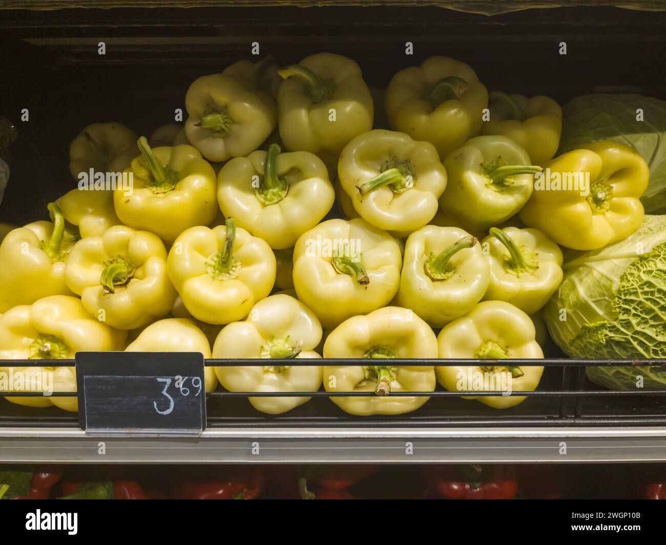 yellow peppers at vegetable rack in supermarket Stock Photo - Alamy