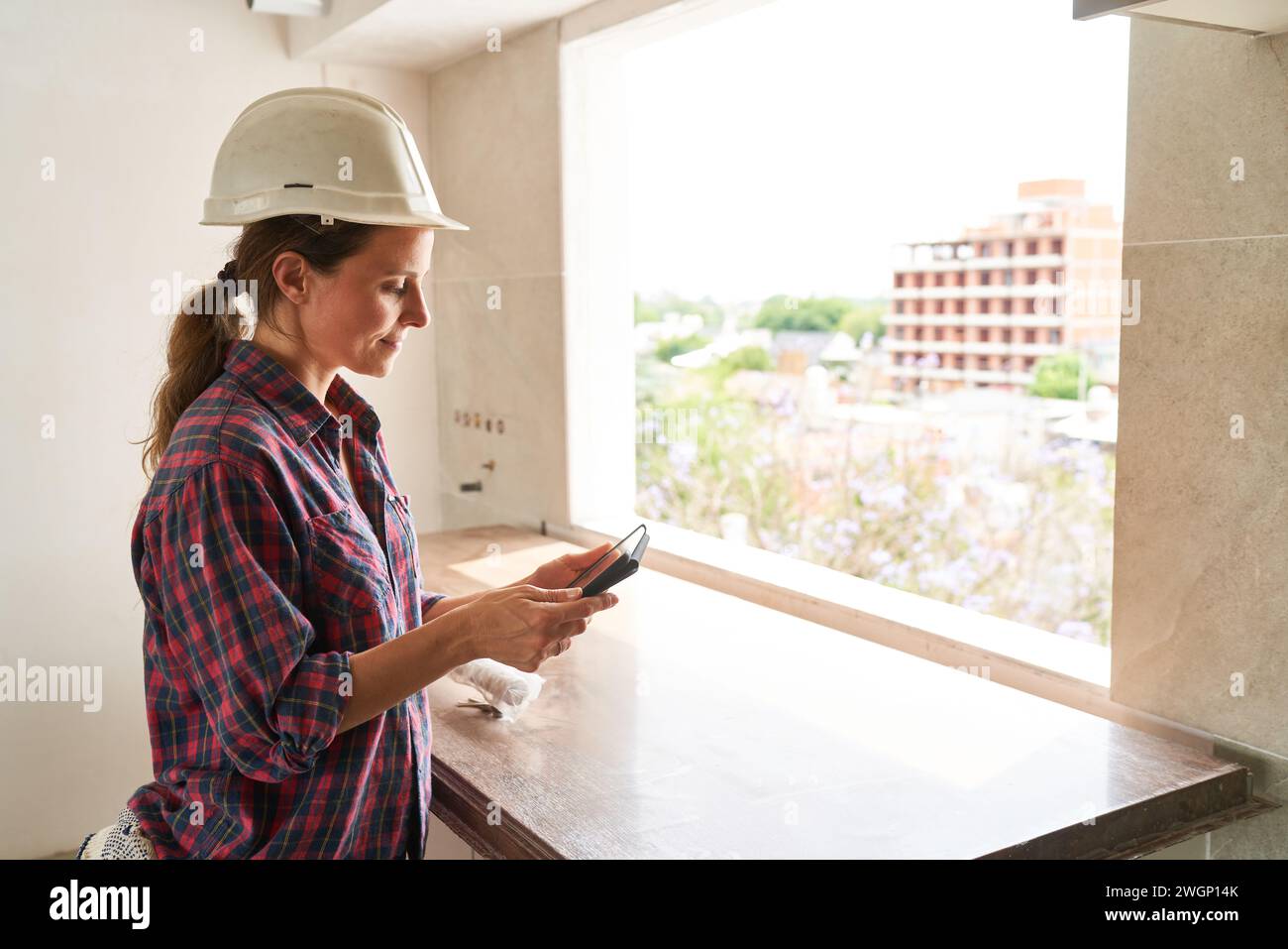Young female contractor using tablet PC Stock Photo