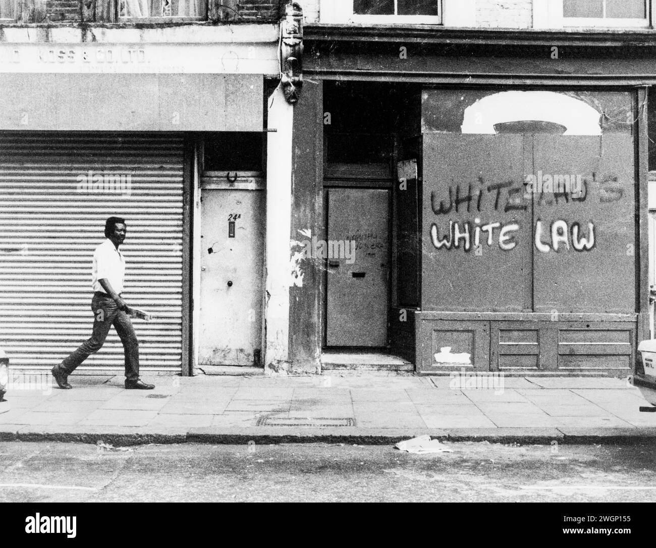 Graffiti on a shop front, 22 All Saints Road near the Mangrove Restaurant, Notting Hill, London, 1971. The restaurant was opened in 1968 by civil rights campaigner Frank Crichlow and was a meeting place for local Black community. Frequently raided by police leading to protests and a famous trial in 1971. The trial of the Mangrove Nine drew public attention to police racism, and turned the fight against it into a cause célèbre.The graffiti 'Whitelaws - White Law' alludes to the Conservative Home Secretary William Whitelaw and the position of the Conservative government to policing and racism. Stock Photo