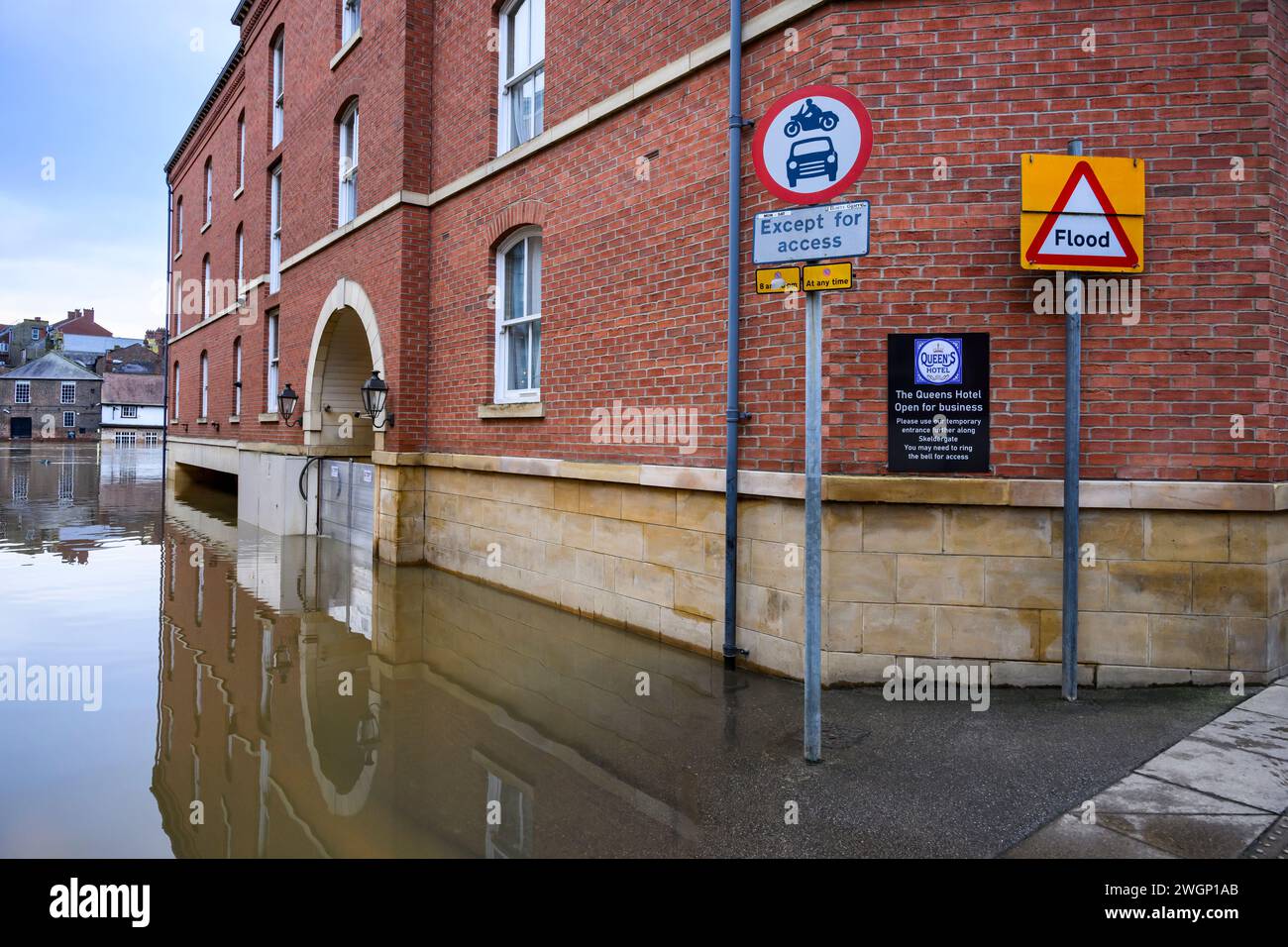 River Ouse burst banks after heavy rain (riverside submerged, high level, premises flooded, flood barrier shut) - York, North Yorkshire, England, UK. Stock Photo