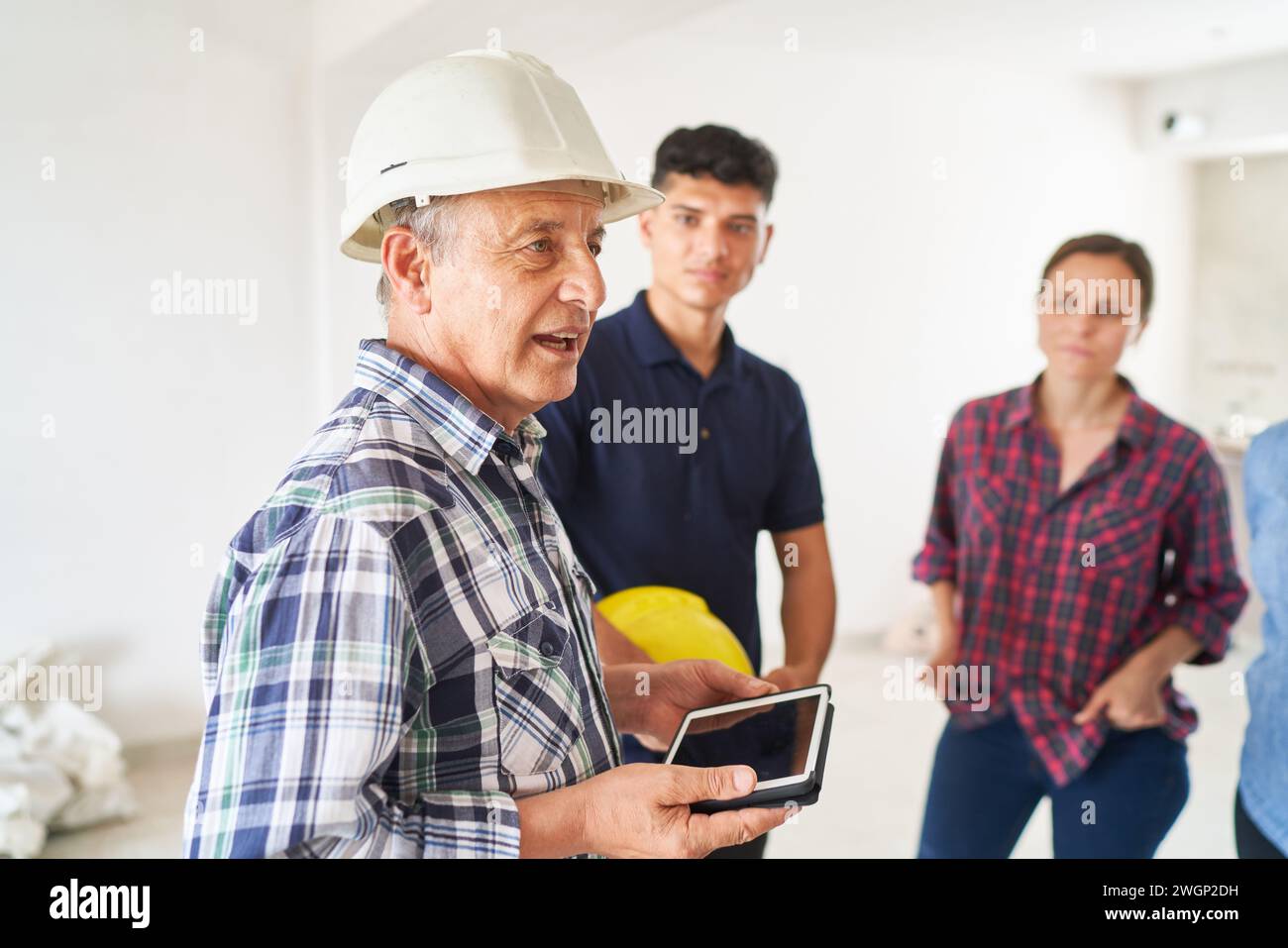 Senior architect discussing with workers Stock Photo