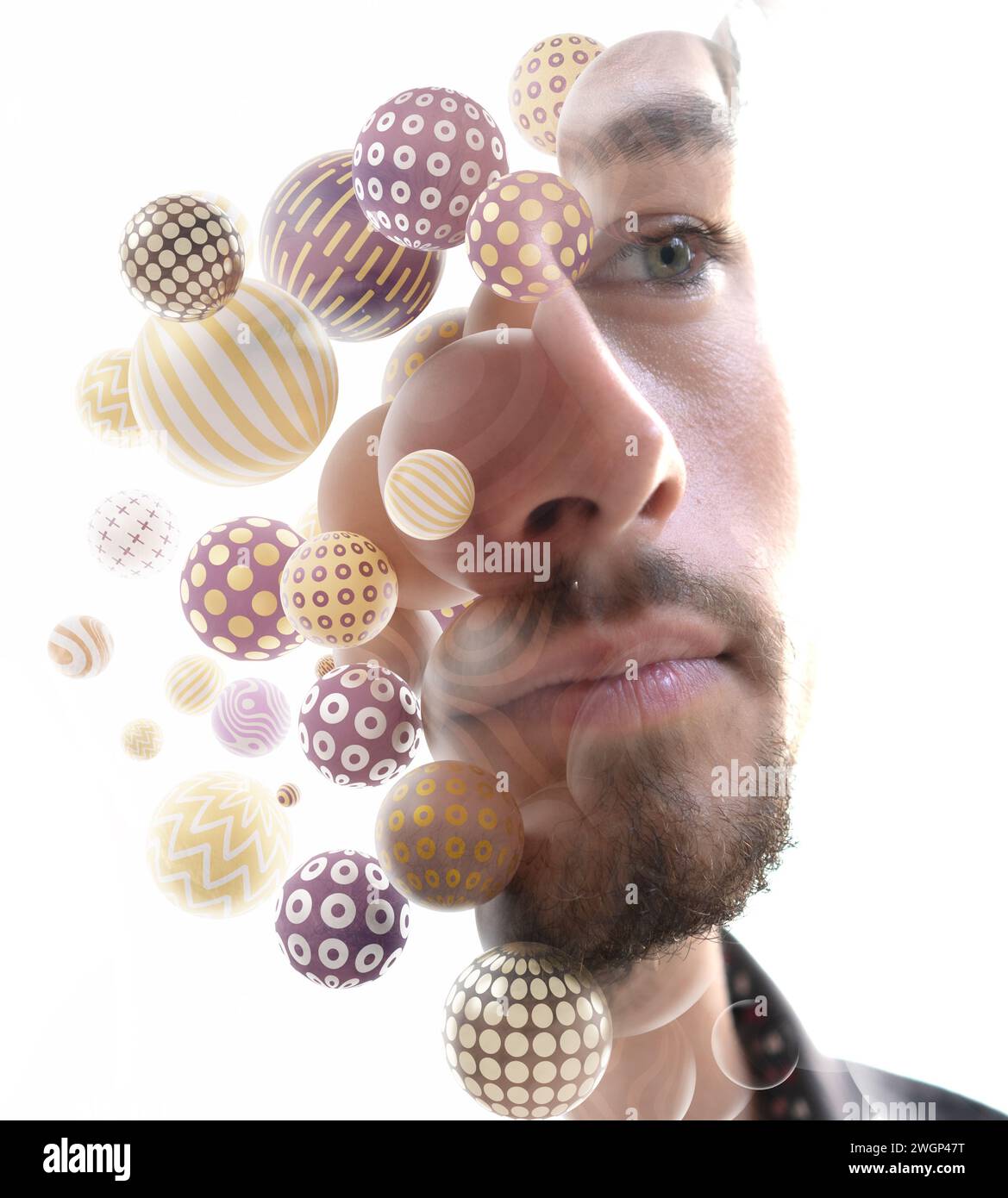 A double exposure close-up portrait of a young man combined with 3D spheres. Stock Photo