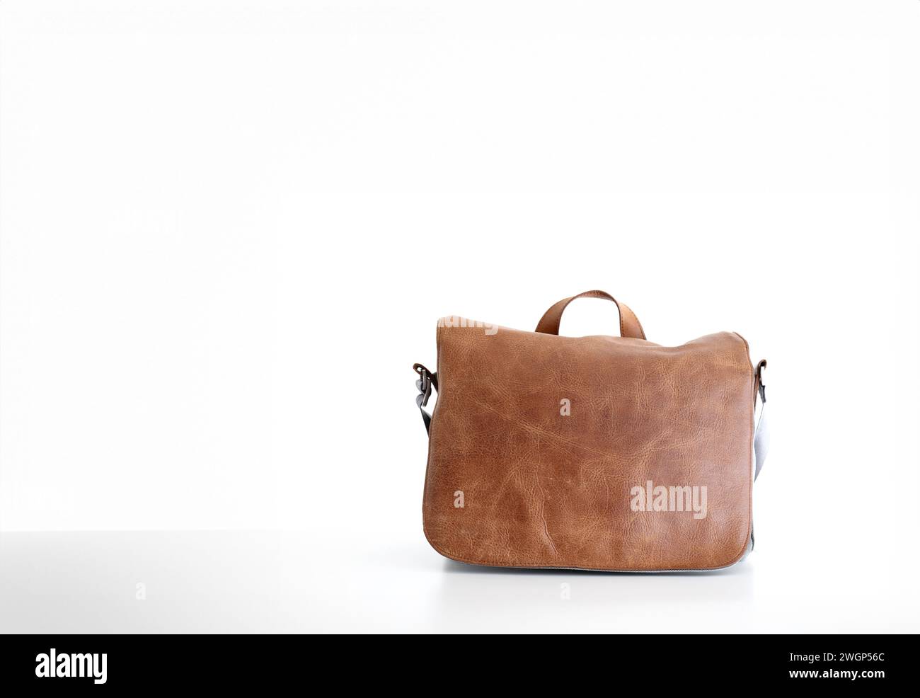 Brown fake leather men's messenger bag, isolated on white. Stock Photo