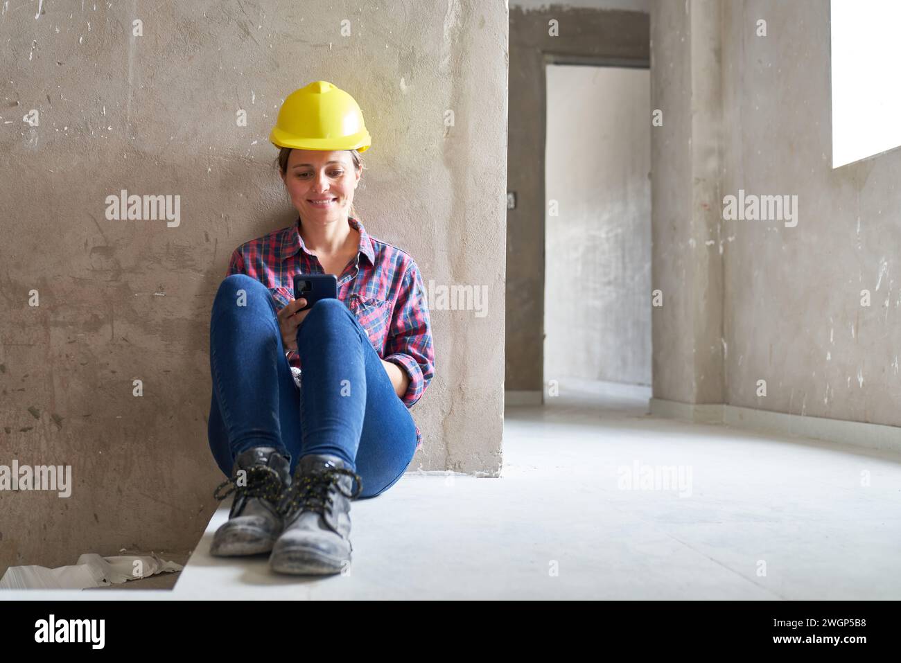 Smiling female worker using smart phone Stock Photo