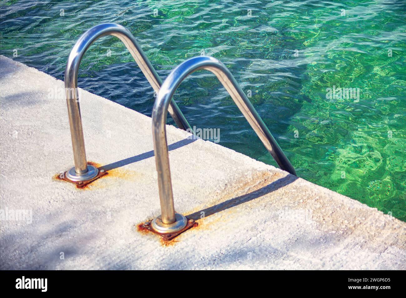 Stainless steel railing on the pier with turquoise water Stock Photo ...