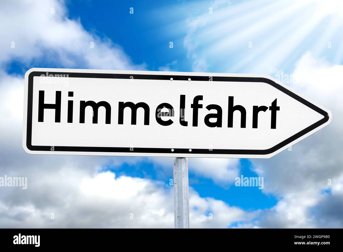 6 February 2024: Sign with the inscription:Ascension Day. Catholic holiday Ascension Day concept against a blue sky PHOTOMONTAGE *** Schild mit der Aufschrift: Himmelfahrt. Katholischer Feiertag Christi Himmelfahrt Konzept vor blauem Himmel FOTOMONTAGE Stock Photo