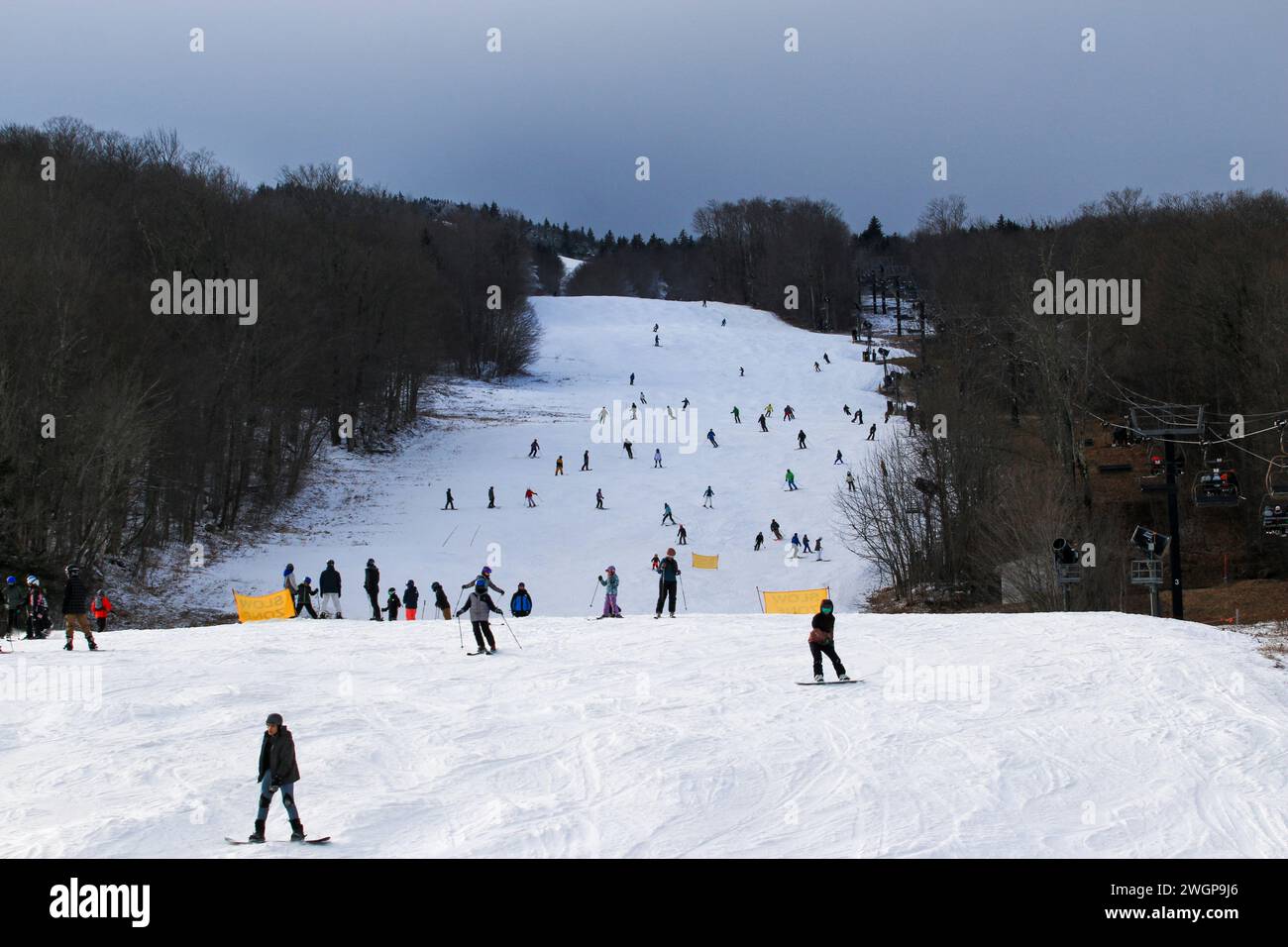 West Dover, Vermont, USA - 31 January 2023: Many skiers and snowboarders enjoying New Years Eve day on the slopes of Mt. Snow in Vermont USA. Stock Photo