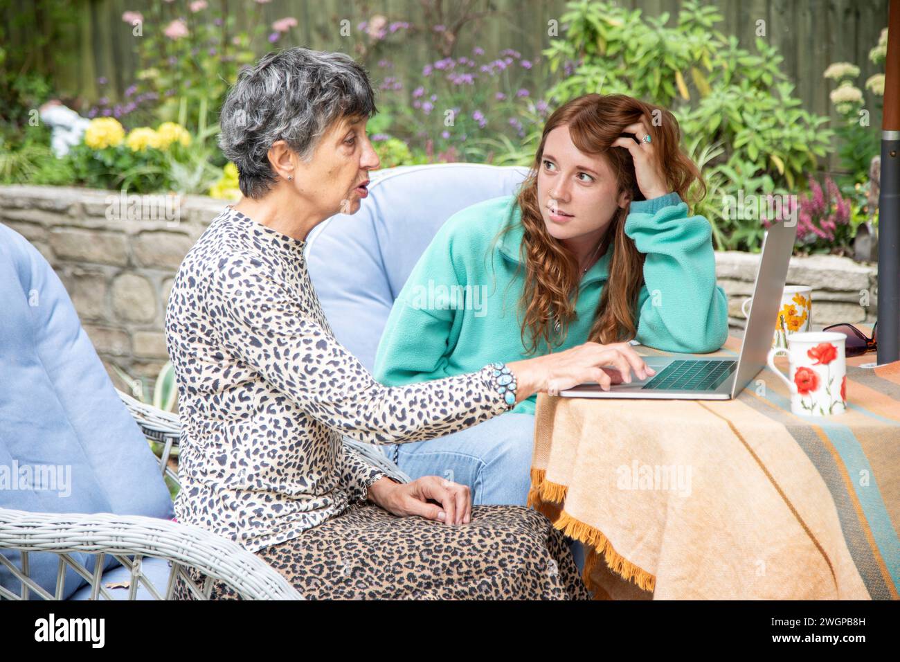 Granddaughter is concerned about Grandmas activity on-line protecting her from being catfished / scammed Stock Photo