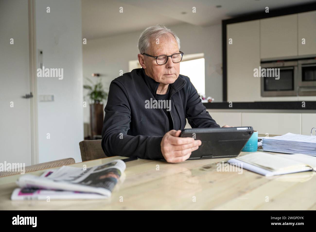 Man working at his desk at home, studying energy bills Stock Photo