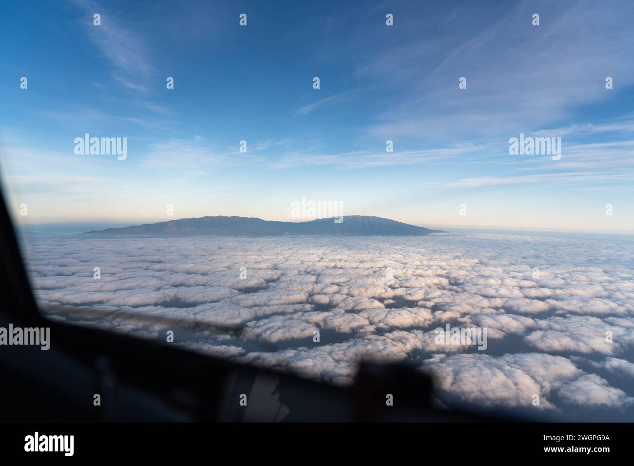 Cockpit view of an aircraft in flight over the clouds Stock Photo