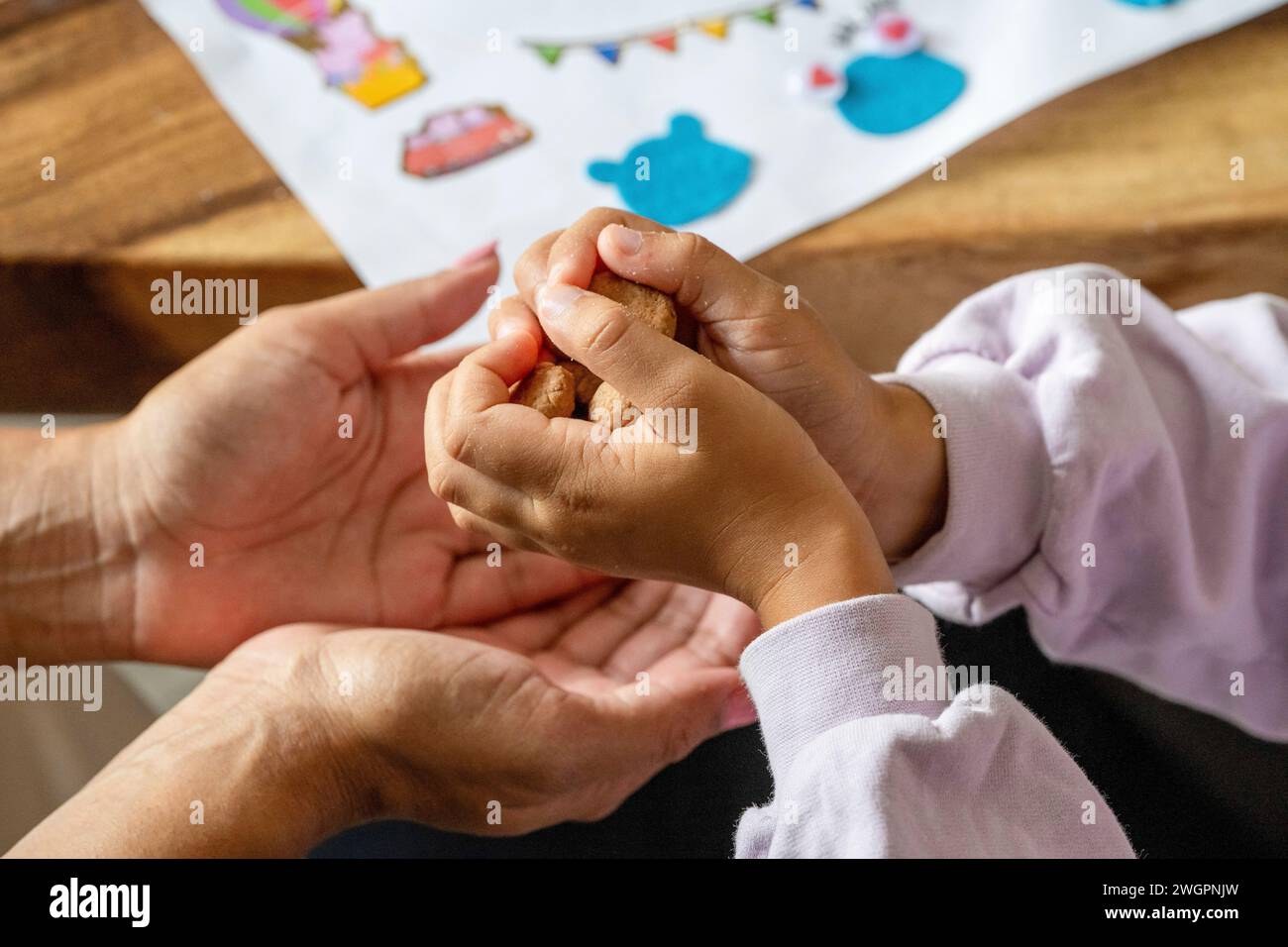 Mother and son playing a game at the table. Stock Photo